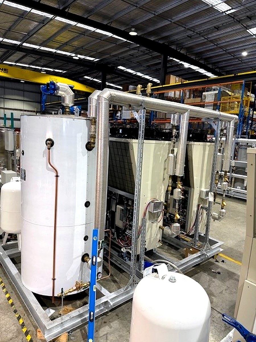Sheet metal cladding on heat exchange skid units and associated pipe connections in a factory